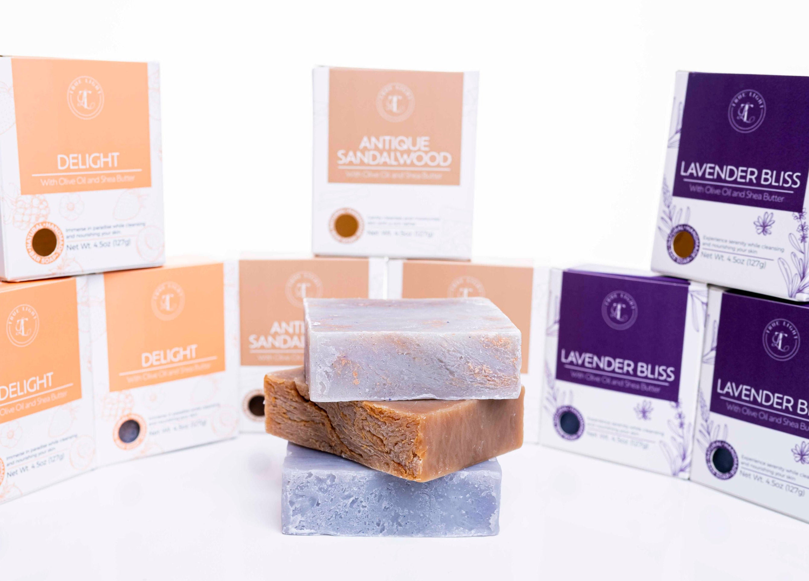 Collection of soap bars and packaging with brand labels on a white background